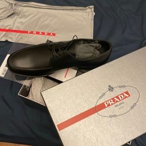 Brand new never worn Prada dress shoes come in box with travel bag